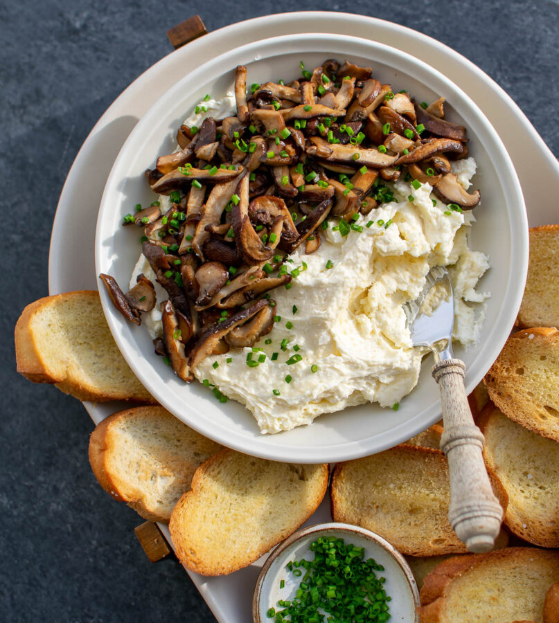 Whipped Camembert Butter with Mushrooms served with crostini and chives.