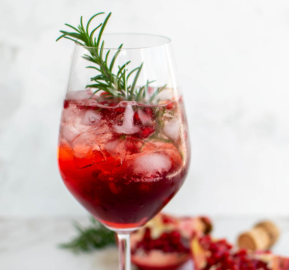 Close up photo of the Pomegranate Campari Spritz in a glass.