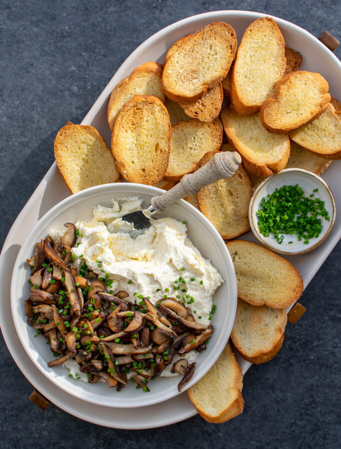 Whipped Camembert Butter with Mushrooms served with crostini and chives.